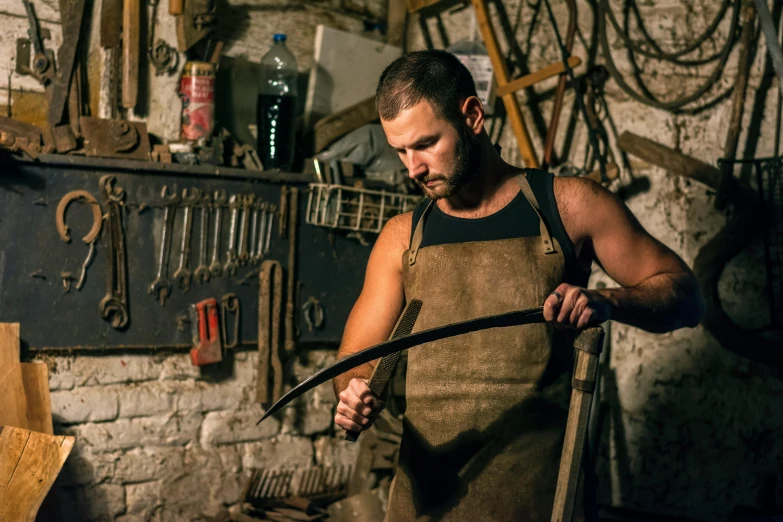 man wearing apron while holding handle on wood shaving