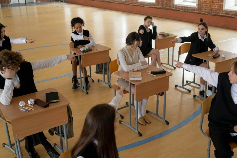a group of young people sitting at desks in a school
