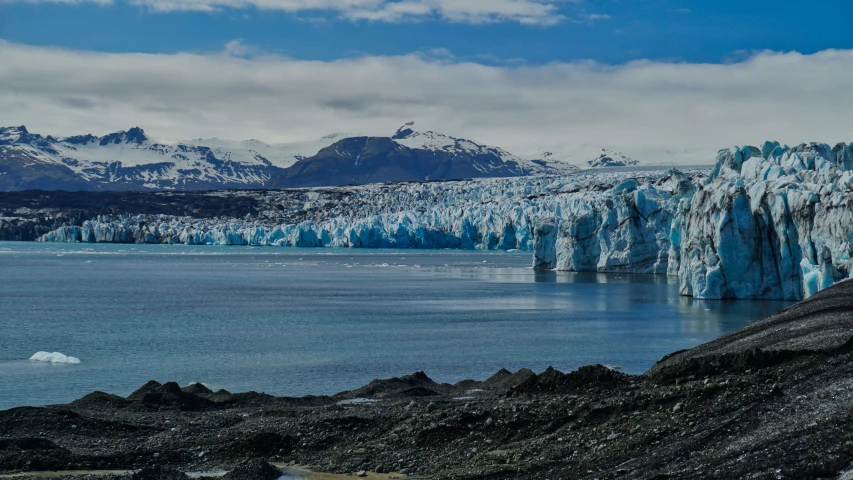 some mountains and a body of water with ice on them