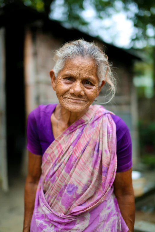 an older indian woman is smiling at the camera