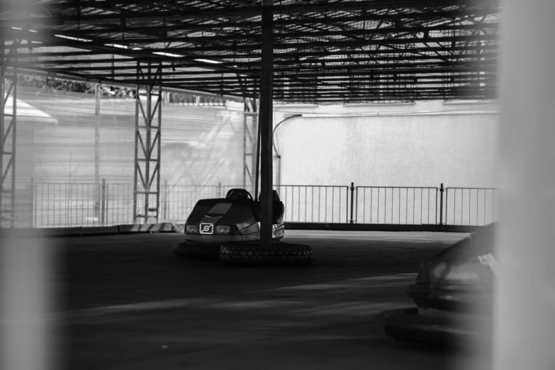 a parking lot with the door open, and a person on a go - cart