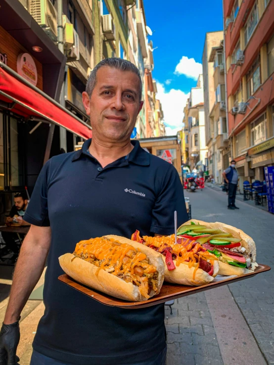 a man holding two  dogs on top of tray