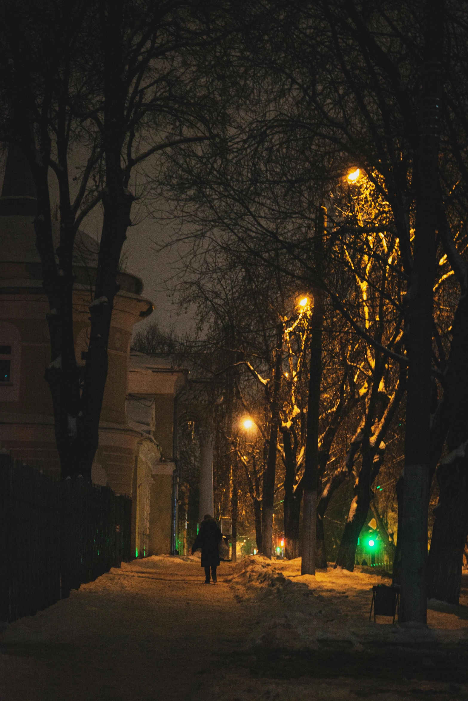 a person walking down the street in the middle of night