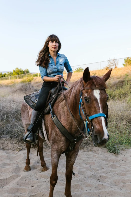 a woman is sitting on top of a horse