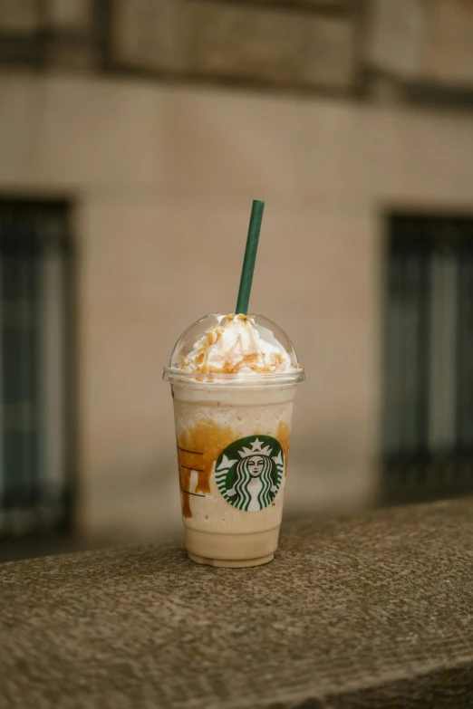 a starbucks drink is topped with whipped cream