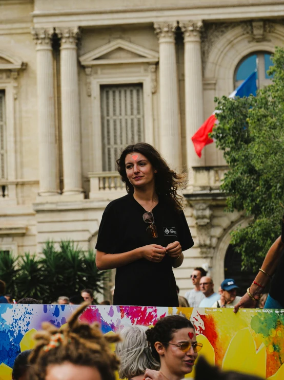 a woman is talking on her cell phone while in the crowd