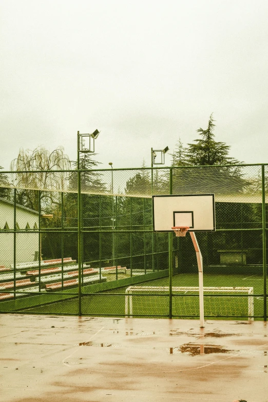 an empty basketball hoop in front of an empty field