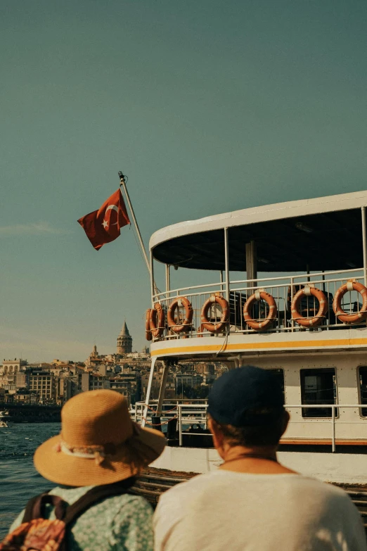 two people standing in front of a boat