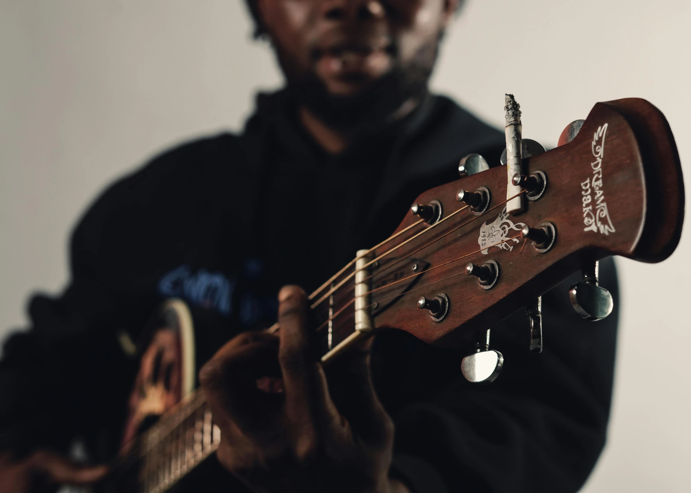 a man is playing a guitar with his hands