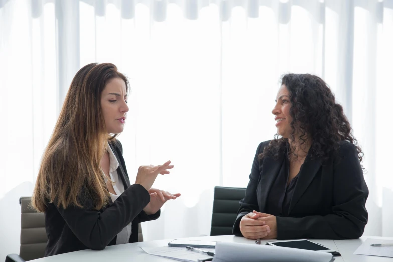 two women who are sitting at a table