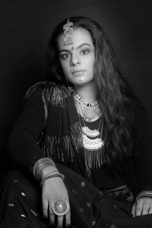 a woman in an ethnic indian outfit posing