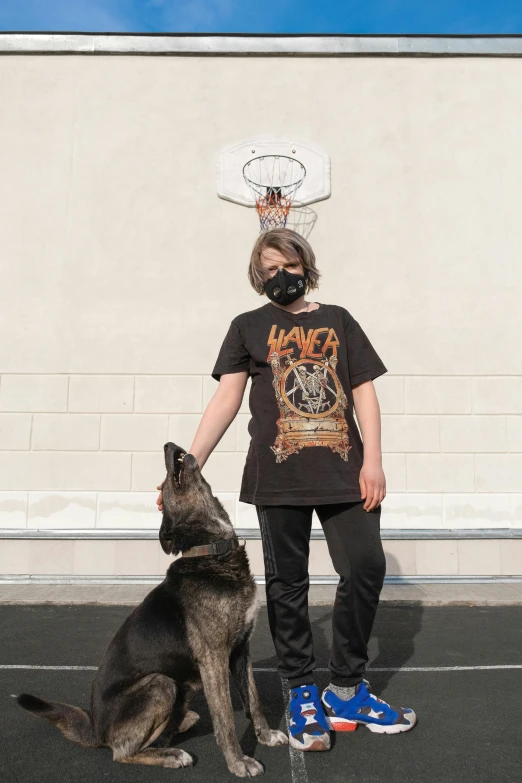 a person sitting down with a dog in front of a building