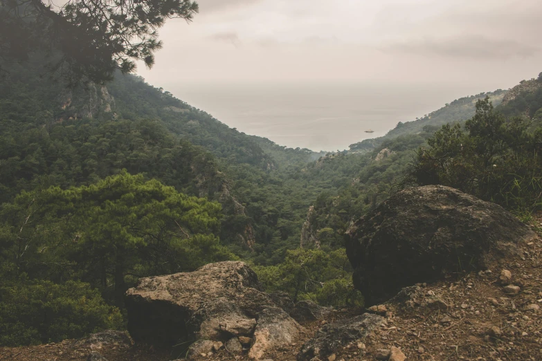 a mountain view, showing the ocean in the distance