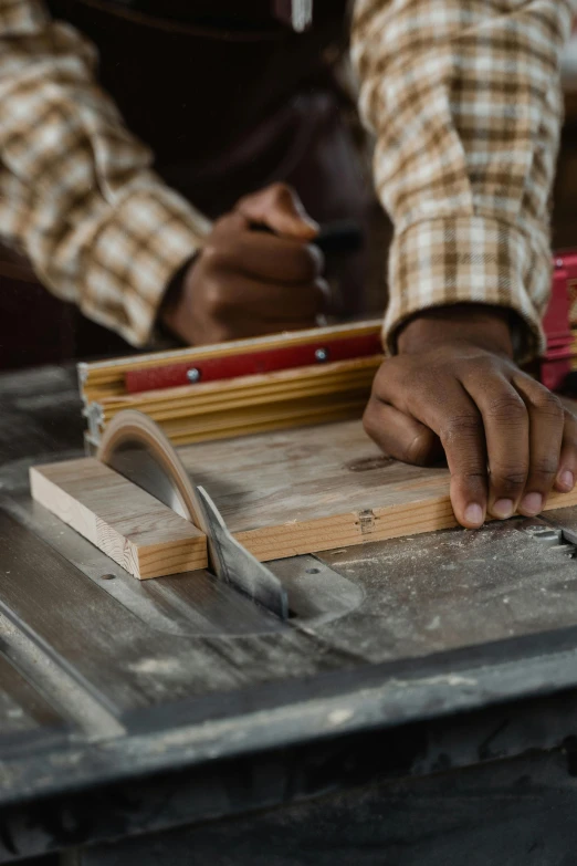 the man is doing a project with many wood tools