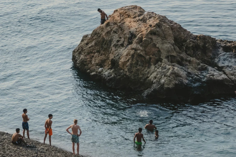 children are swimming and playing in the ocean