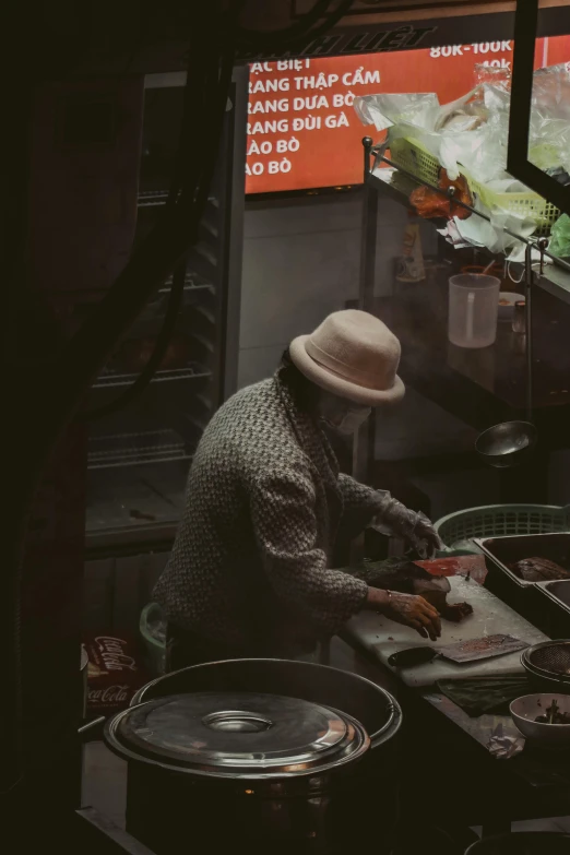 a woman in a hat is preparing food on a table
