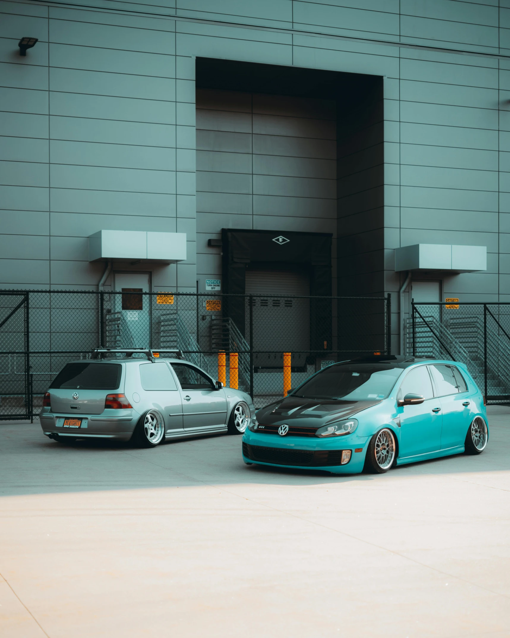 two cars are parked in front of a building