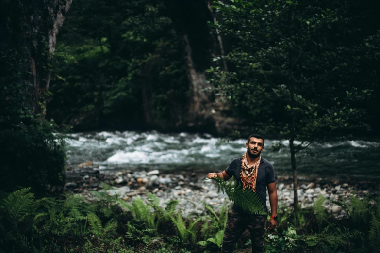 a man with some kind of object in the woods