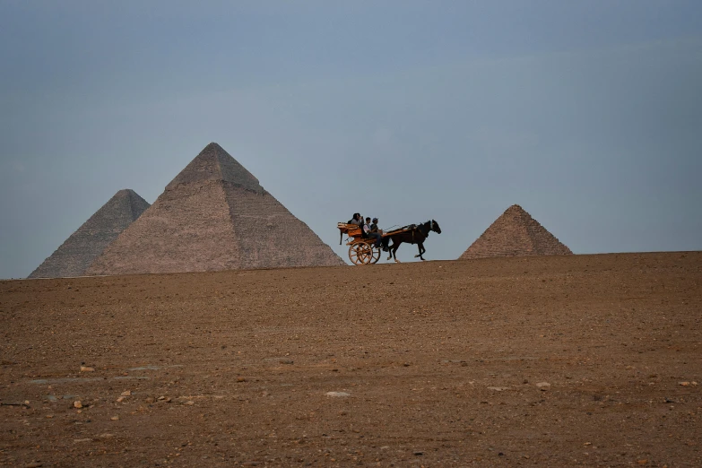 a person that is in front of three pyramids