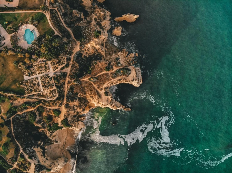 an aerial view of some houses and some water