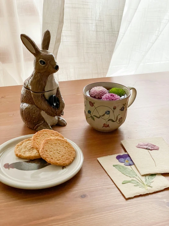 a table topped with cookies and bunny figurines