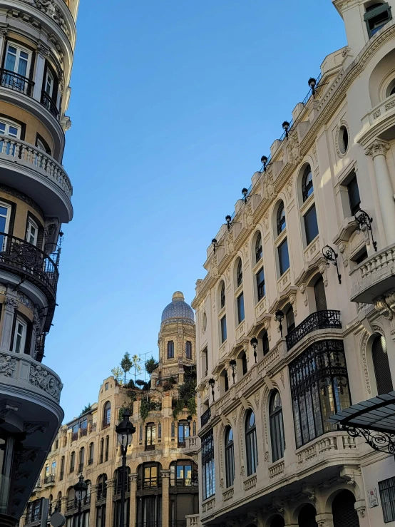 several buildings line the street on one side and another in the distance