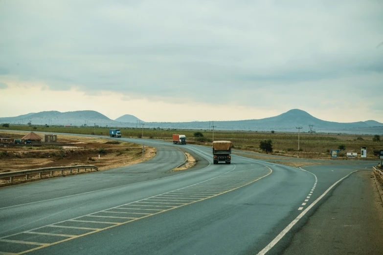 some trucks driving down the road together