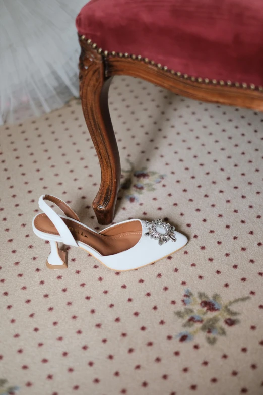 a pair of shoes sitting on the ground near a foot rest