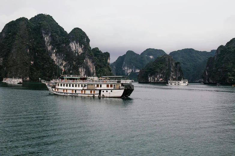 two boats on water with mountains in the background