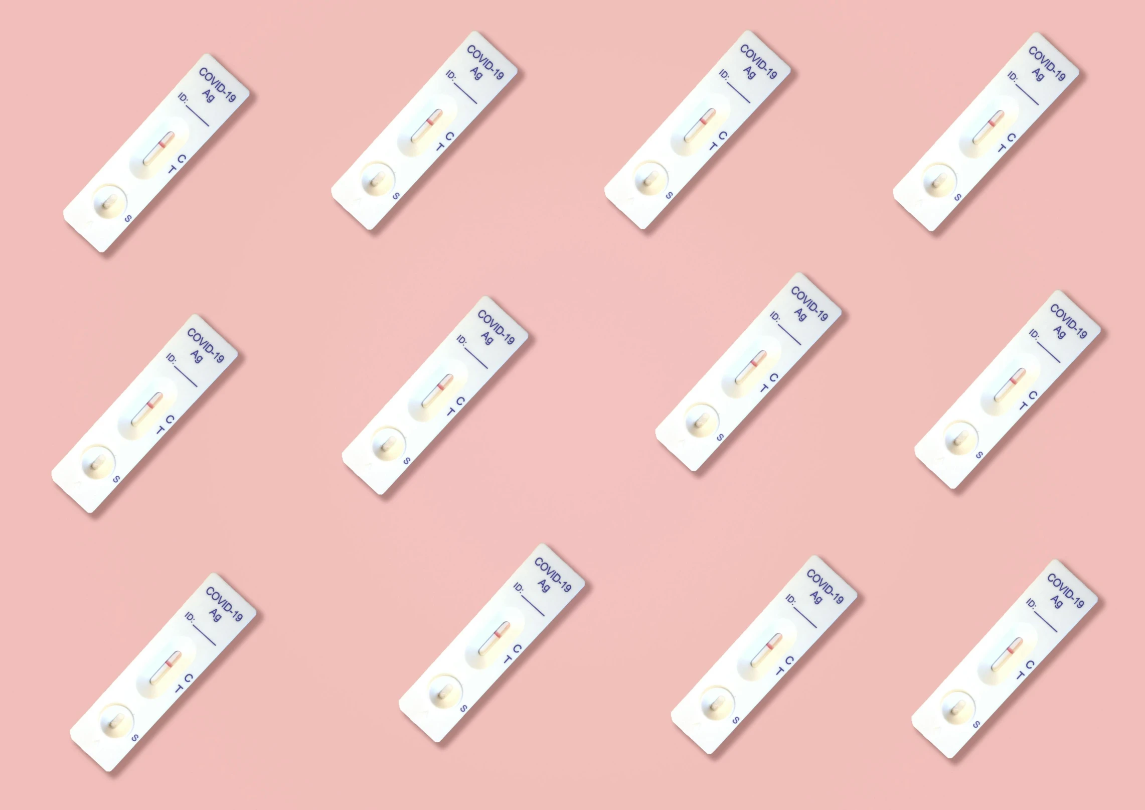 white electronic batteries lined up together on pink background