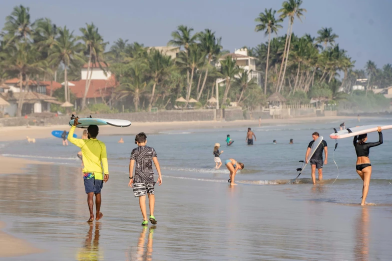 a group of people standing in the sand at a beach