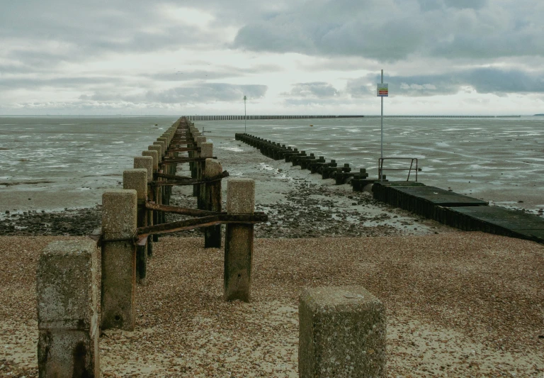 a large long dock sits on the beach