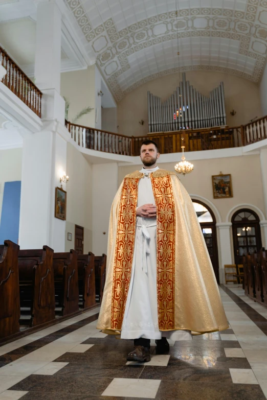 a priest in the cathedral posing for a po