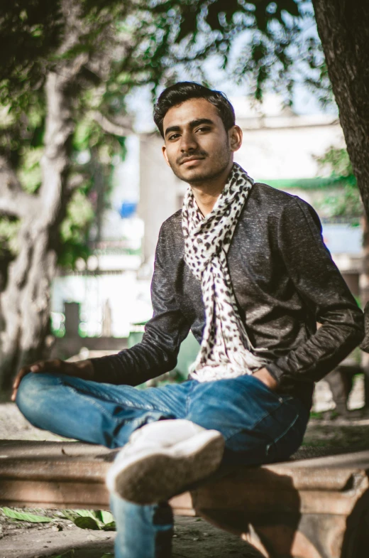 man sits in a park on a park bench