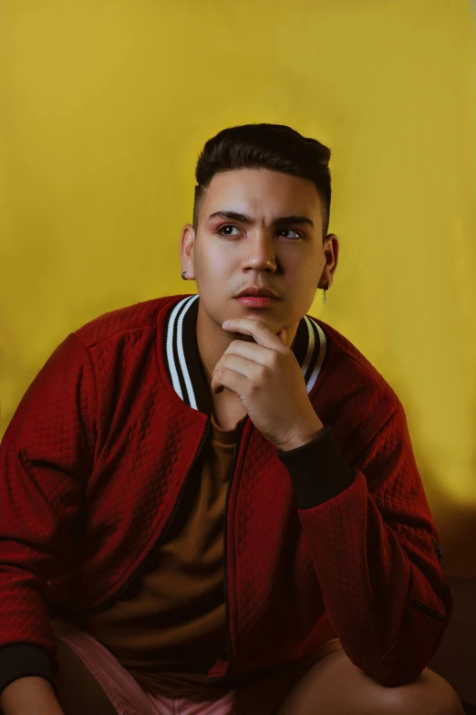 an image of a man wearing a jacket and sitting