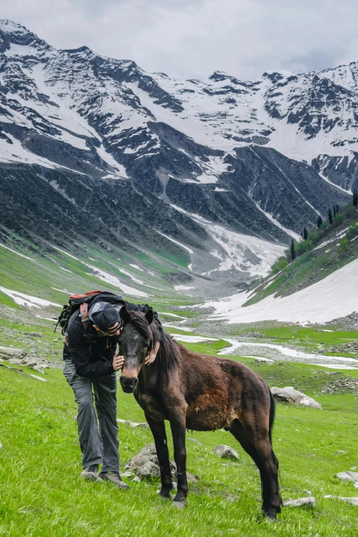 a man who is holding his animal in a field