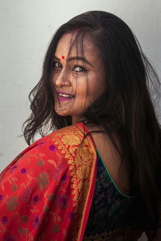 an indian woman wearing a red and gold dress