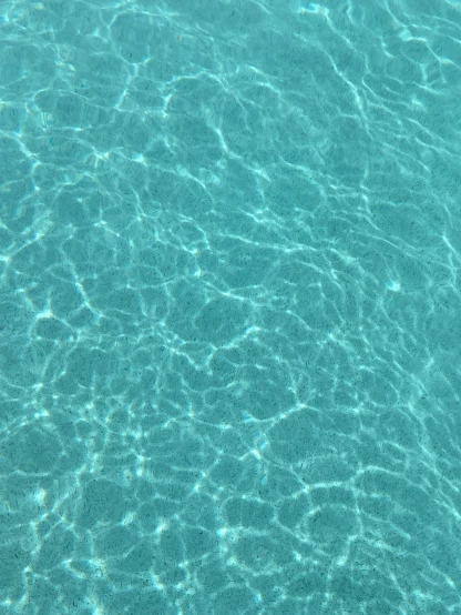 clear blue water and the ripples of sunlight make it look like soing out of water