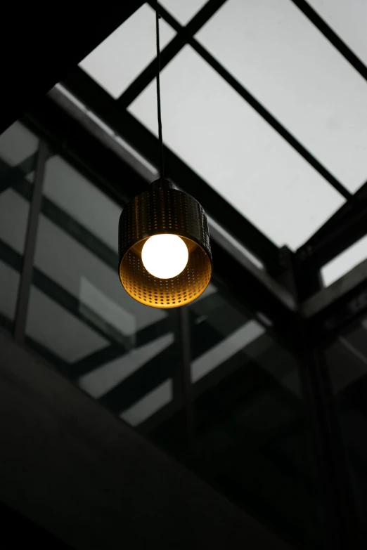 a room with a glass ceiling and light fixture