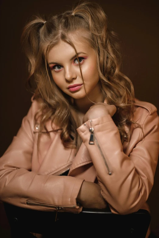 a girl with red makeup wearing a pink jacket