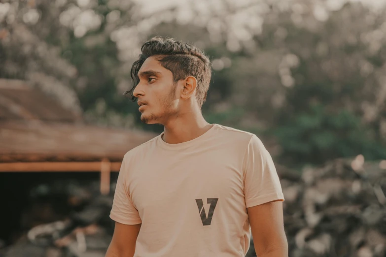 the young man with dreadlocks stands in a park