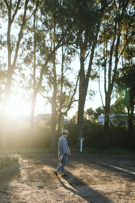 a man walks down a path in the woods