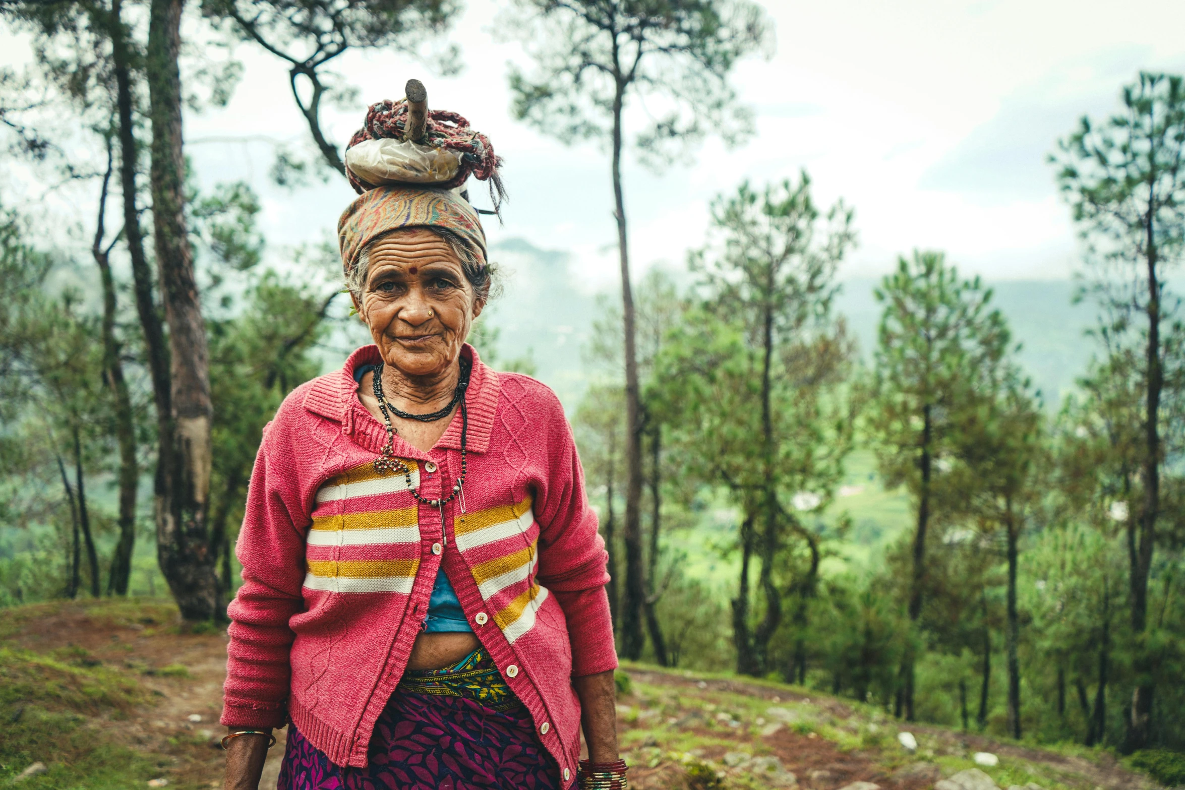 a woman with an elaborate headdress on in the wilderness