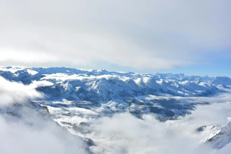 a person looking out from above the clouds in the mountains