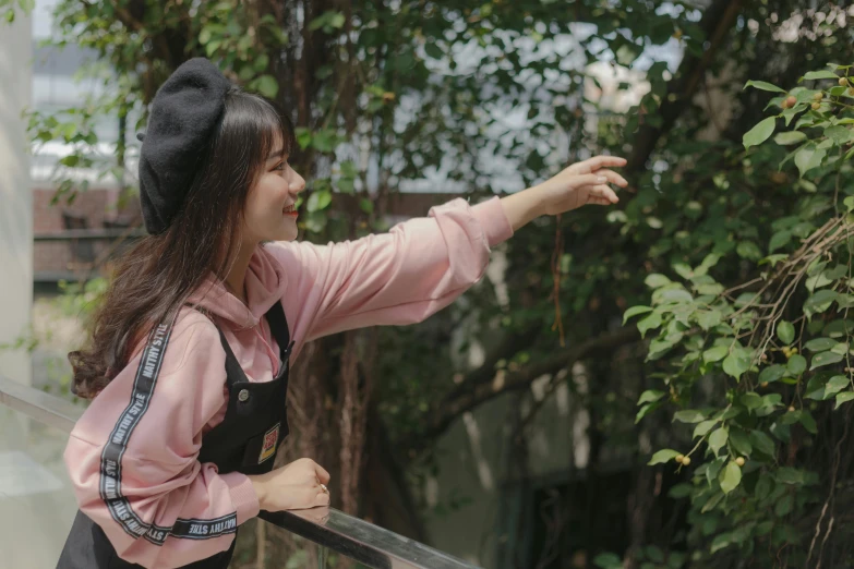 a girl is wearing an apron and black hat