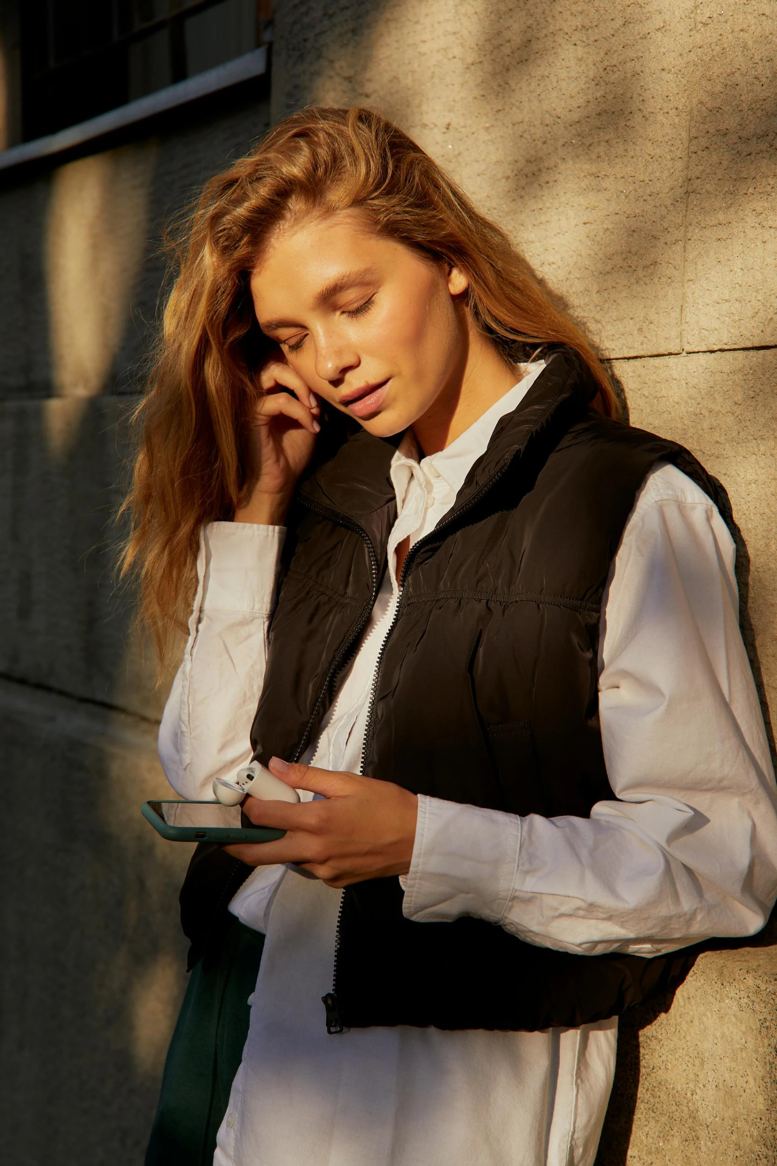 a woman stands and talks on her cellphone