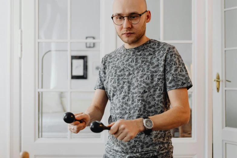 man wearing glasses holding a wood balancer