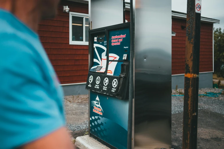 the man is trying to get his money from a vending machine