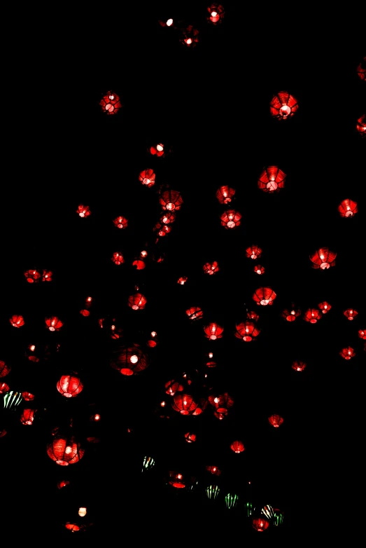 a bunch of red balls floating in the air