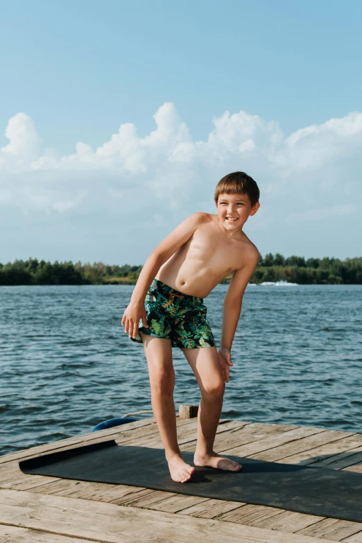 a  stands on a floating mat near the water